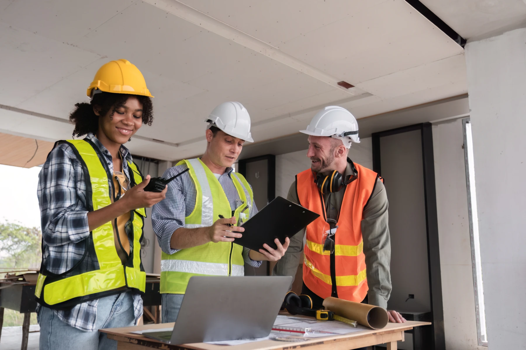 Construction Workers Reviewing Plans at Construction Site