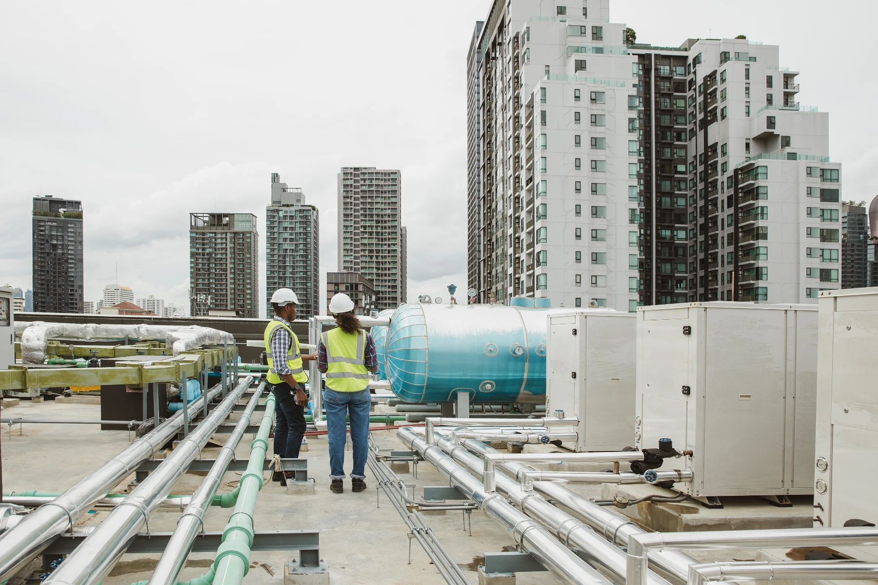 Engineers Inspecting Building Systems on Rooftop
